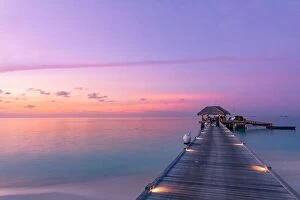 Images Dated 16th December 2018: Amazing sunset landscape at Maldives. Luxury resort villas seascape with soft led lights under