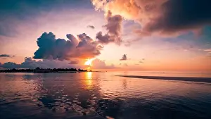 Sunset Beach Prints: Amazing tropical sea and island reflection in sunset light in Maldives beach