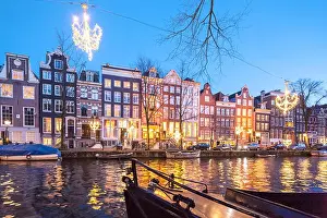 Canalside Prints: The Ambassade Hotel on the Amsterdam Herengracht Canal in winter with seasonal Christmas lights