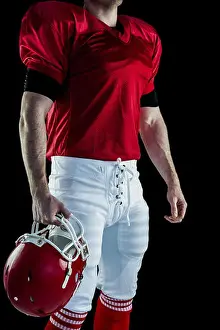 Sports Uniform Prints: American football player holding his helmet