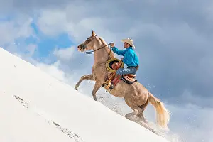 Mare Prints: American Paint Horse. Rider (Claus Theurer) with mare climbing up a kaolin sandhill