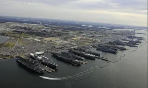 Carriers Prints: Six amphibious ships and five aircraft carriers are moored at Norfolk