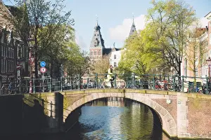 Amsterdam people riding bicycles in historical part in Amsterdam, Netherlands