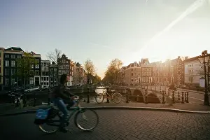 Amsterdam people riding bicycles in historical part in Amsterdam, Netherlands