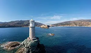 Hora Prints: Andros Island. Greece. The stone lighthouse on a rock aerial drone view
