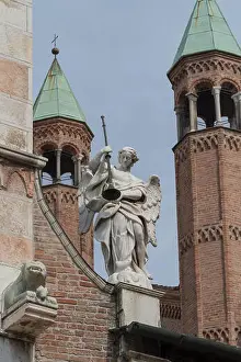 Angel holding a trumpet on the facade of Cremona Cathedral, Lombardy region, Italy