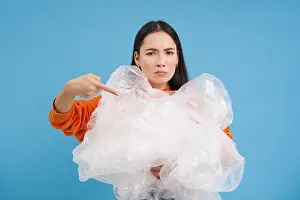 Litter Prints: Angry eco-activist points at big pile of plastic bags