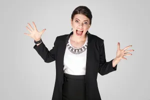 Aggressive Prints: Angry woman scream and shout. Studio shot, indoor. Isolated on grey background