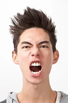 Oriental Ethnicity Prints: Angry young man screaming against white background