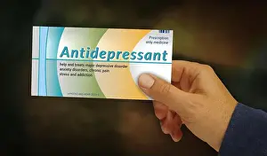Asleep Prints: Antidepressant tablets box in hand