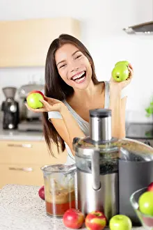 Weight Loss Prints: Apple juice - Woman making apple juice on juicer machine at home in kitchen