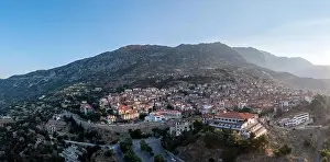 Sunray Prints: Arachova Greece mountain town aerial drone view at sunrise