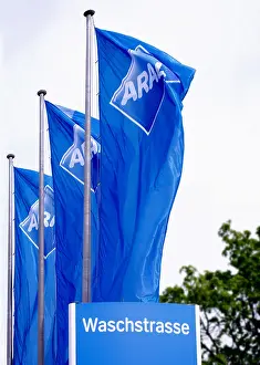 Concern Prints: Aral flags blowing in the wind, at a car wash