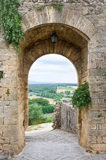 Arch Prints: Arched doorway in a medieval stone wall in the Tuscan village of Monteriggioni