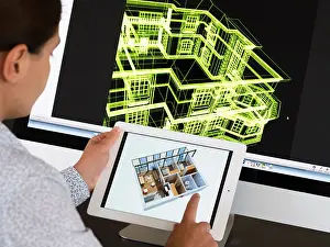 Ipad Prints: Architect using iPad CAD Computer Aided Design application to model 3D layout design of new house