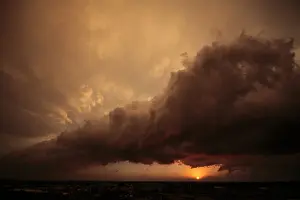 Thunderstorm Prints: Arcus or roll cloud at sunset lit from beneath by setting sun