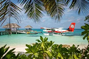 Ari Atoll, Maldives - 05.05.2019: Maldives seaplane on luxury resort, wooden jetty loading the plane, ready for departure. Tropical island background