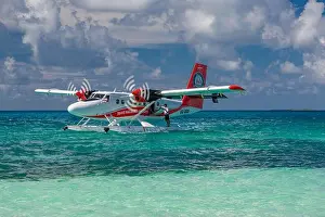 Ari Atoll, Maldives - 05.05.2019: Maldives seaplane on luxury resort, wooden jetty loading the plane, ready for departure. Tropical island background