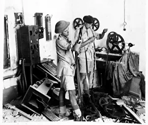 Fascist Prints: Army Film Unit personnel search a cinema projection room at the former Fascist headquarters in Regalbuto