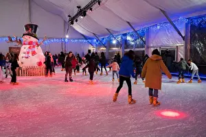 Christmas Decoration Prints: Artificial ice skating rink in El Pilar square during Christmas holidays in Zaragoza