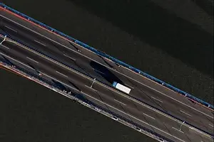 Cable Bridge Prints: Top ascending aerial view of cable- stayed Can Tho bridge road with driving cars
