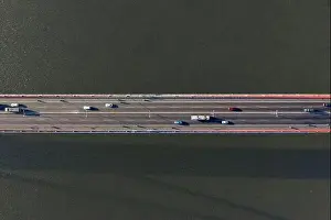 Cable Bridge Prints: Top ascending aerial view of cable- stayed Can Tho bridge road with driving cars
