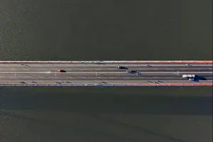 Top ascending aerial view of cable- stayed Can Tho bridge road with driving cars