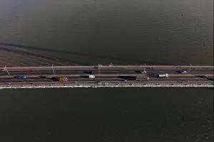 Top ascending aerial view of cable- stayed Can Tho bridge road with driving cars
