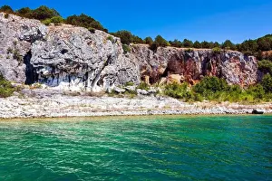 Green Water Prints: An ascetic building nestled into the rocky cliffs along the shore of Megali Prespa Lake