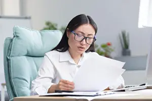 Exhausted Prints: Asian business woman behind paper work