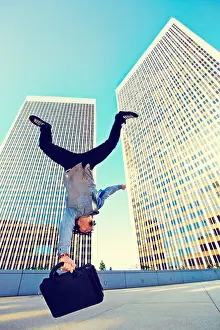 Highrise Prints: Asian businessman doing back flip on urban rooftop
