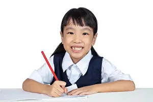 Preschooler Prints: Asian Chinese little girl wearing school uniform studying in isolated white background