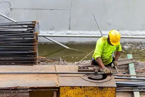 Reinforcement Prints: asian construction worker is using steel bending machine bender rebar for casting foundation concrete pillars