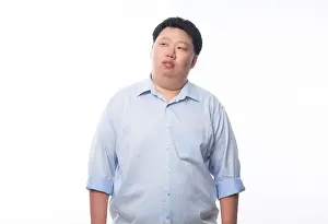 Obese Prints: Asian fat man in blue shirt thinking and looking to copyspace isolated on white background