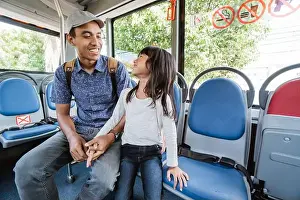 Daddy Prints: asian father taking his daughter to school by riding bus public transport