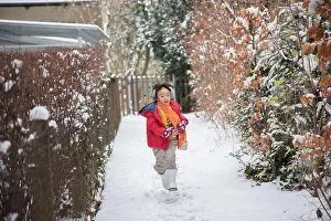 Winter Travel Prints: Asian Girl playing with snow in Switzerland, Europe