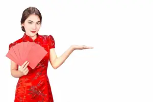 Asian girl in traditional and take Red envelopes chinese new year
