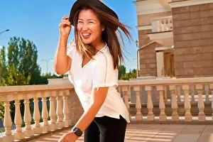 Dentistry Prints: An Asian girl wearing a white T-shirt and a dark hat has dental braces