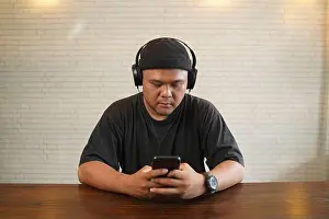 Headphone Prints: Asian guy wearing beanie and black t-shirt listening to music by headphones