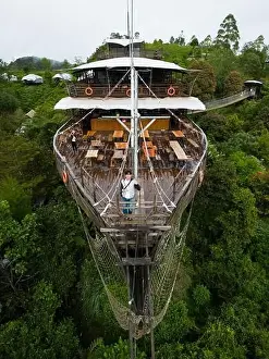 Asian Tourist Posing on Deck of Large Wooden Ship Restaurant in Lembang Forest