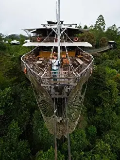 Asian Tourist Posing on Deck of Large Wooden Ship Restaurant in Lembang Forest