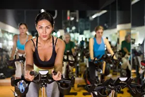Racer Prints: Asian woman with fitness bike in gym