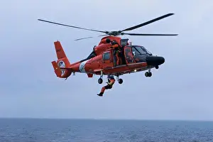AST3 Roberto Ochoa is hoisted down from USGC MH-6567 helicopter