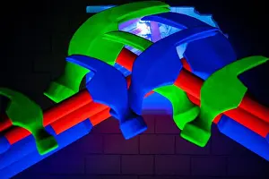 Shimmering Prints: An astonishingly vibrant display of various hammers and intricate pipes illuminated in brilliant neon colors