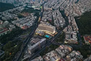 Gods View Prints: Athens, Greece - August 16, 2019: Aerial drone shot of Hilton Athens hotel with pool in dusk time