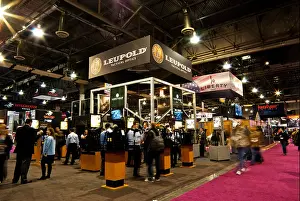 Control Prints: Attendees representatives weapons arms optical accessory manufacturers in motion blur Las Vegas SHOT Show
