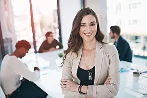 Informal Prints: She has a can do attitude. Portrait of a businesswoman in an office with her colleagues in the background