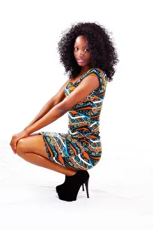 Skinny Prints: Attractive Black Teen Girl In Dress Squatting