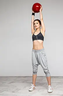 Weights Prints: Attractive sports woman working out with a medicine ball