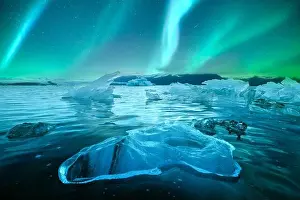 Aurora borealis northen light and icebergs in Jokulsarlon glacial lagoon. Vatnajokull National Park, southeast Iceland, Europe. Landscape photography